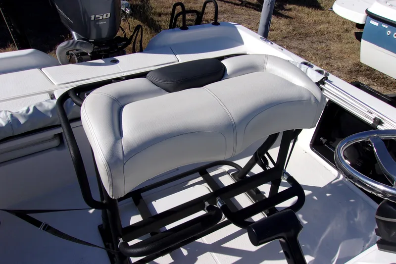 Slide: The Image of 2018 Blue Wave 2200 PureBay boat interior with cushioned seating and steering wheel. - 6