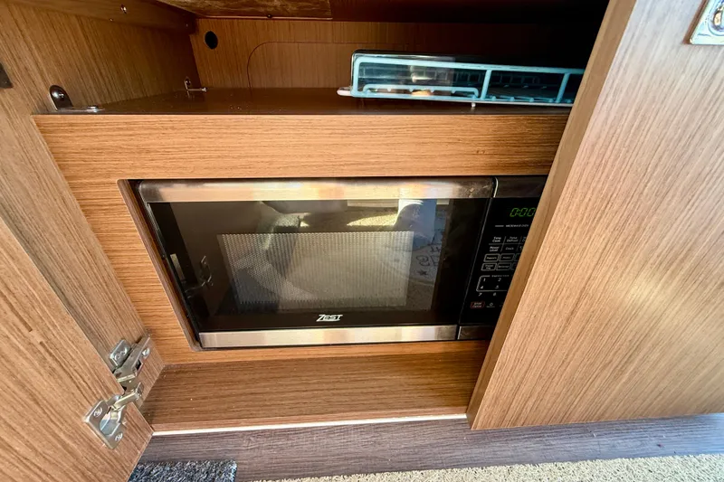 Slide: The Image of Microwave in 2022 Beneteau Antares 9 boat's wooden cabinet interior. - 17