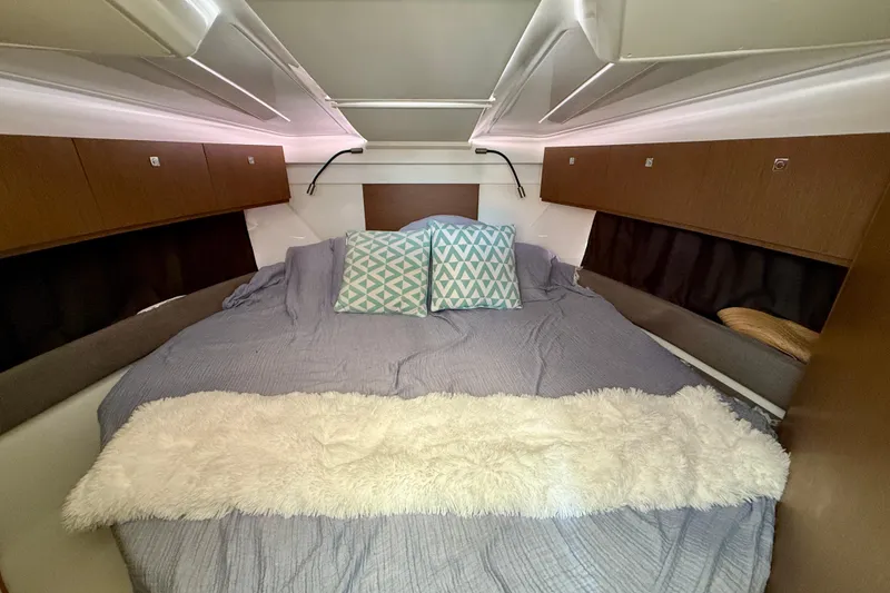 Slide: The Image of Cozy cabin interior of 2022 Beneteau Antares 9 with plush bedding and storage. - 20