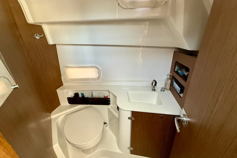 Slide: The Image of Bathroom interior of 2022 Beneteau Antares 9 boat, featuring sink and toilet. - 22