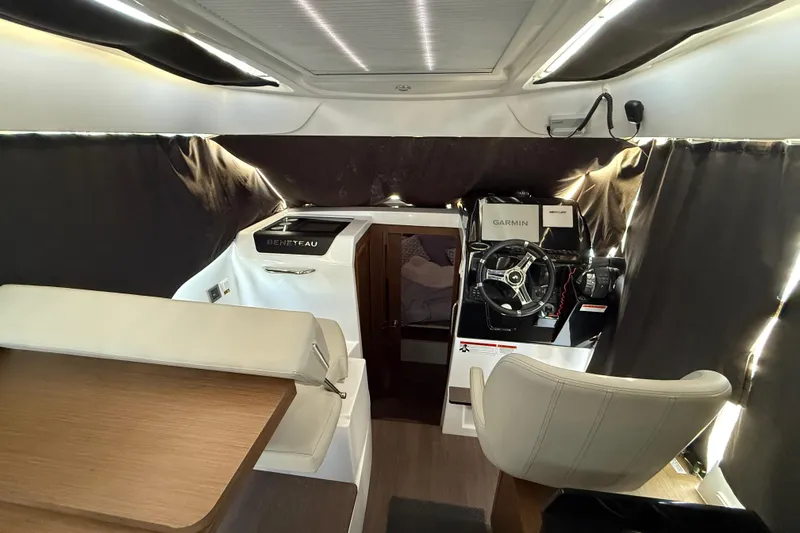 Slide: The Image of Interior of 2022 Beneteau Antares 9 boat with helm, seating, and navigation equipment. - 7
