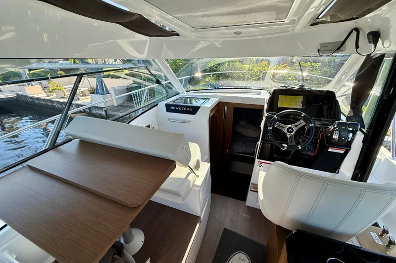 Slide: The Image of Interior of 2022 Beneteau Antares 9 boat with helm, seating, and table. - 8
