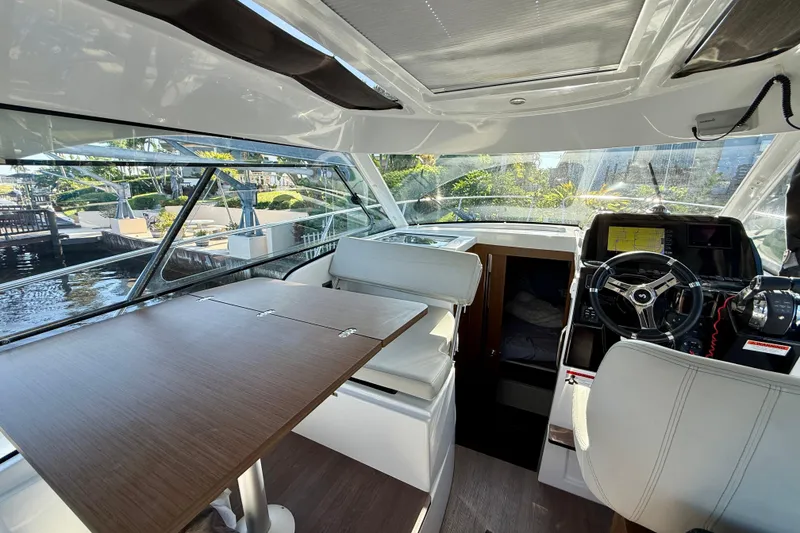 Slide: The Image of Interior of 2022 Beneteau Antares 9 boat with modern helm and seating area. - 9
