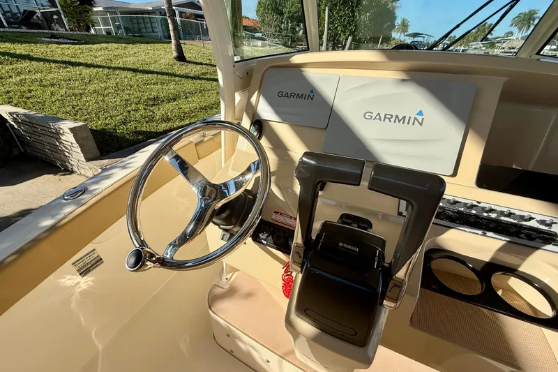 Slide: The Image of 2016 Scout 255 LXF boat dashboard with Garmin displays and Yamaha controls. - 11