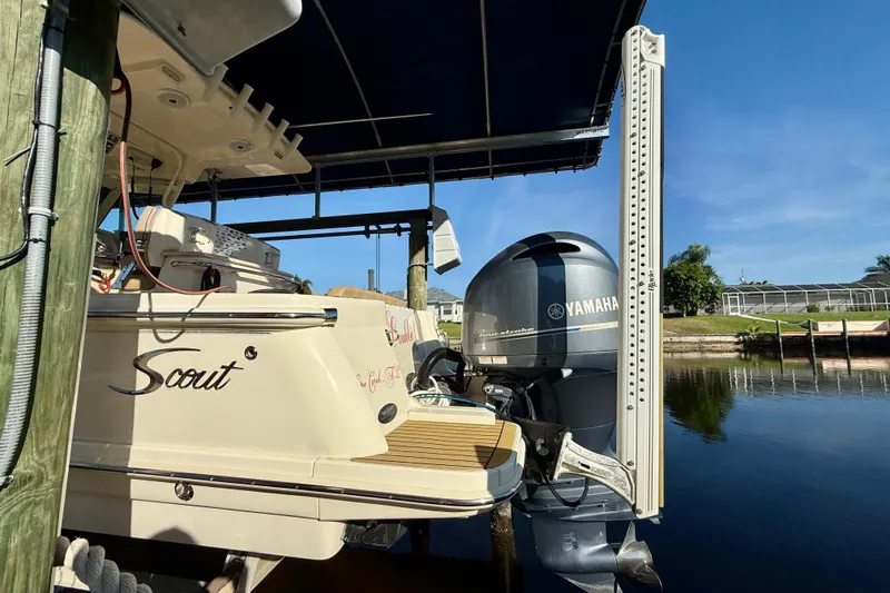 Slide: The Image of 2016 Scout 255 LXF boat with Yamaha engine docked under a canopy. - 3