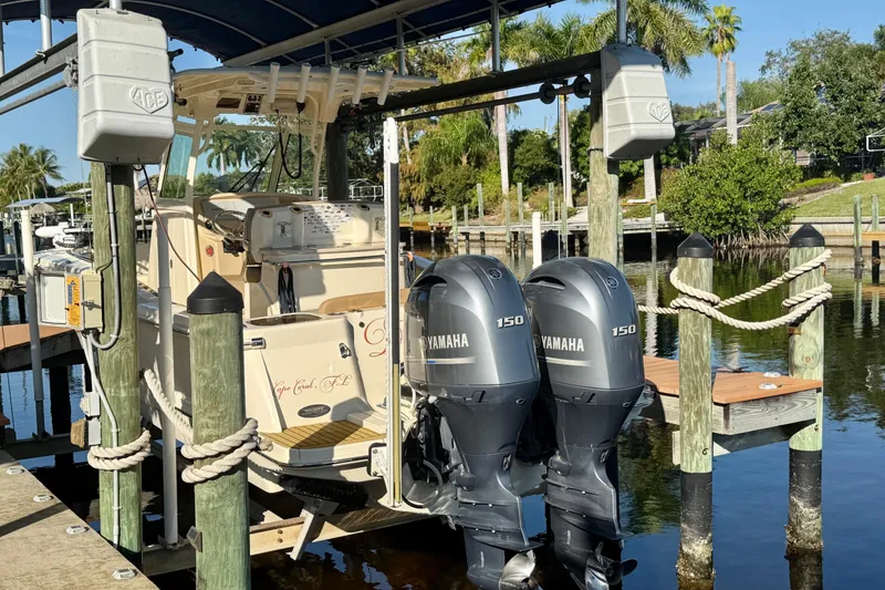 Slide: The Image of 2016 Scout 255 LXF boat with twin Yamaha 150 engines docked at marina. - 4