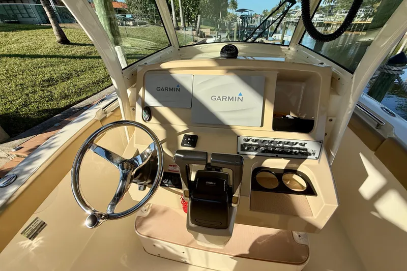Slide: The Image of 2016 Scout 255 LXF boat dashboard with Garmin navigation system and steering wheel. - 8