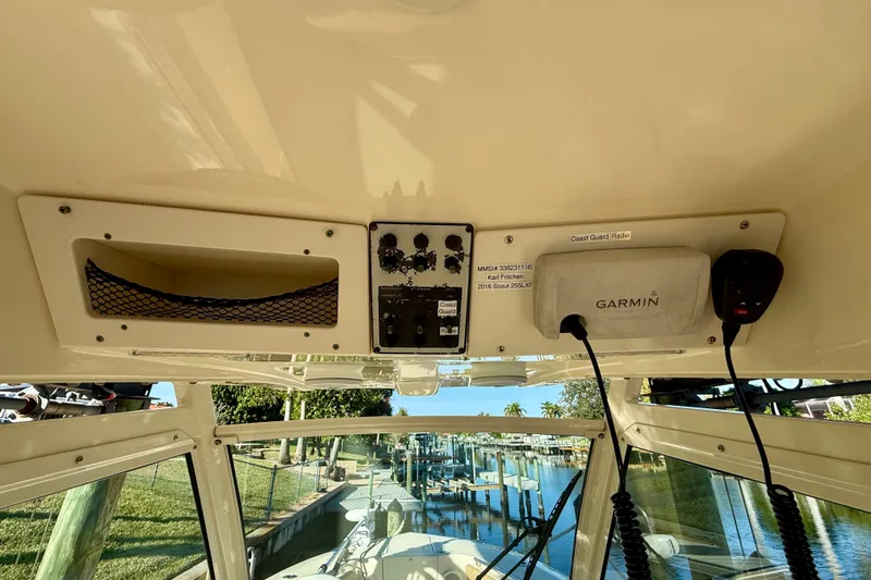 Slide: The Image of 2016 Scout 255 LXF boat dashboard with Garmin device and Coast Guard radio. - 9