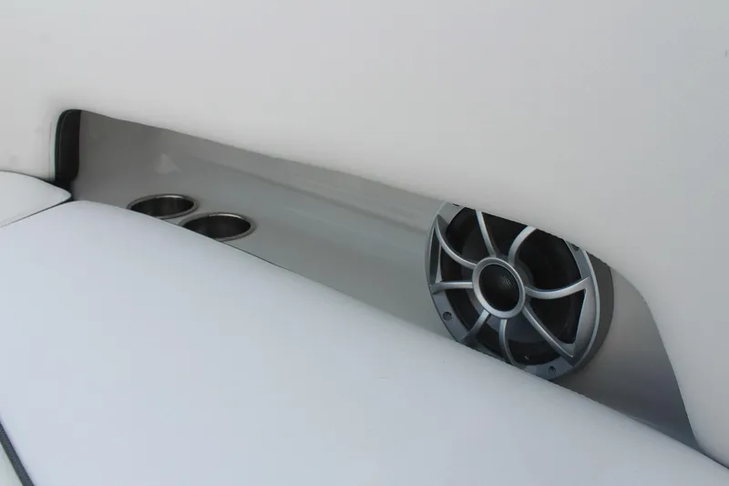 Slide: The Image of 2026 Crownline Eclipse E255 boat interior with speaker and cup holders. - 16
