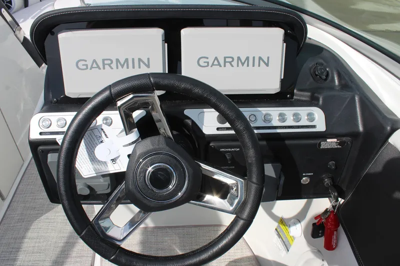 Slide: The Image of Steering wheel and Garmin displays on 2026 Crownline Eclipse E255 boat dashboard. - 20