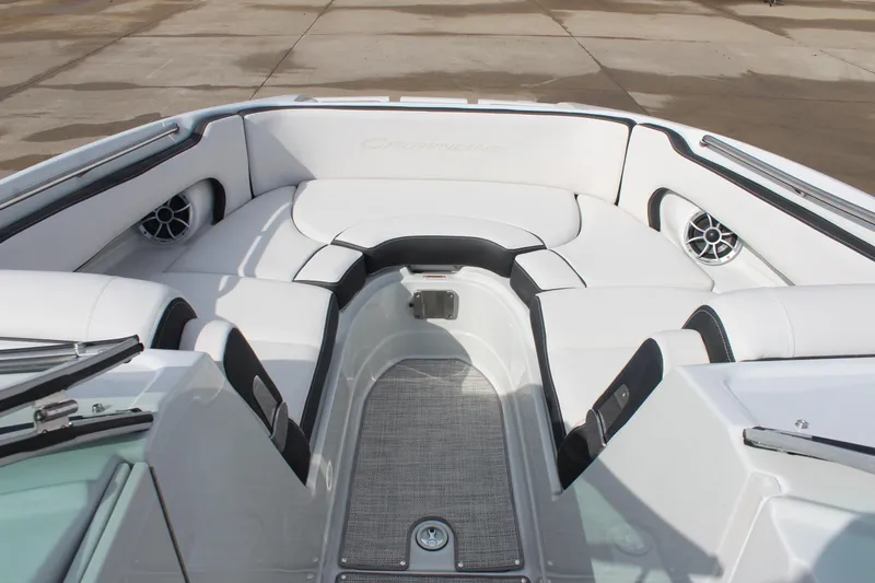 Slide: The Image of 2026 Crownline Eclipse E255 boat interior with white seating and speakers. - 24