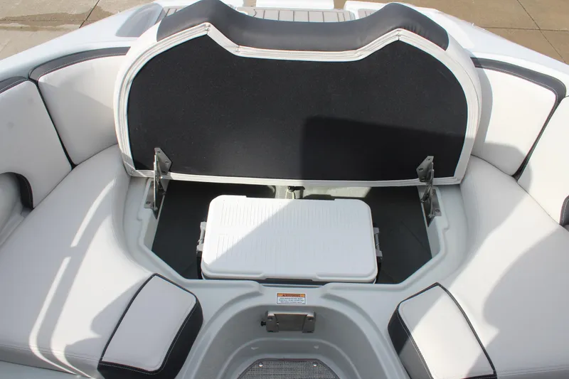 Slide: The Image of 2026 Crownline Eclipse E255 boat interior with open storage compartment and cooler. - 27