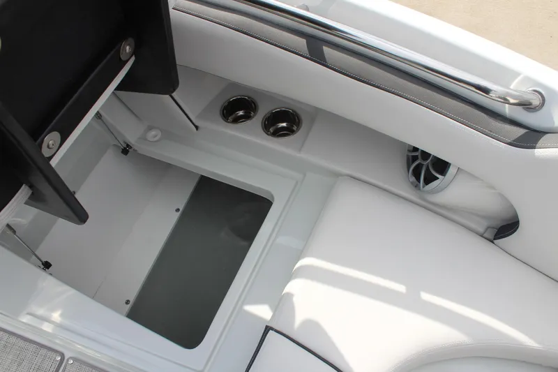 Slide: The Image of 2026 Crownline Eclipse E255 boat interior with storage compartment and cup holders. - 28