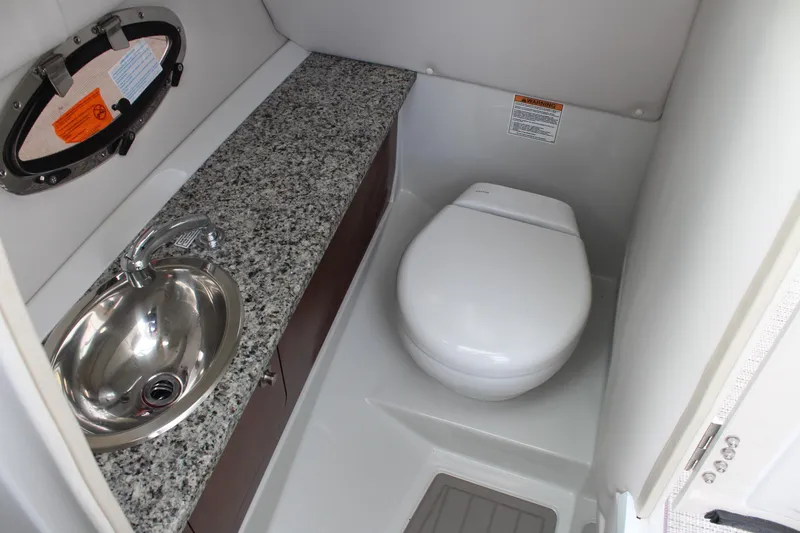 Slide: The Image of 2026 Crownline Eclipse E255 boat bathroom with granite countertop and stainless steel sink. - 33