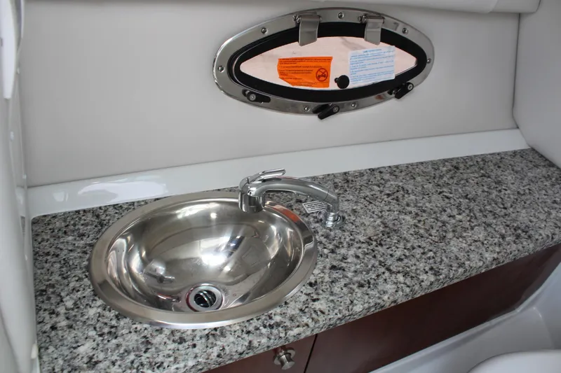Slide: The Image of 2026 Crownline Eclipse E255 boat interior with granite countertop and stainless steel sink. - 35