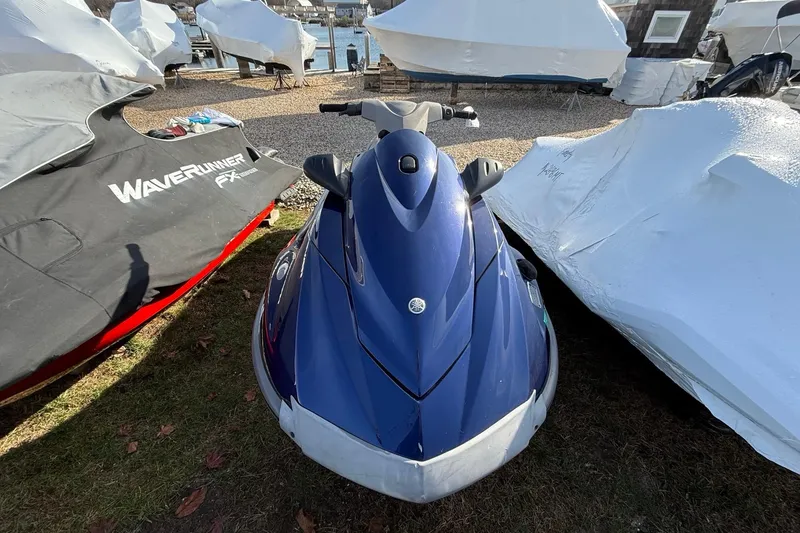 Slide: The Image of 2014 Yamaha WaveRunner VX Deluxe, blue, parked outdoors with protective covers nearby. - 5