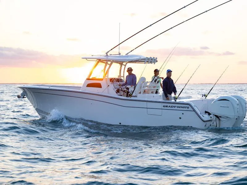 The Image of 2025 Grady-White Canyon 306 boat on water at sunset with people fishing. - 1