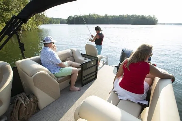 Slide: The Image of Pontoon boat Veranda Fish 22F2, 2026 model, with people fishing on a serene lake. - 8