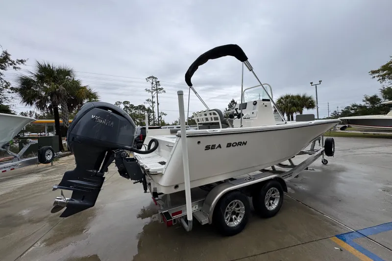 Slide: The Image of 2026 Sea Born LX21 Center Console boat on trailer, parked outdoors. - 10