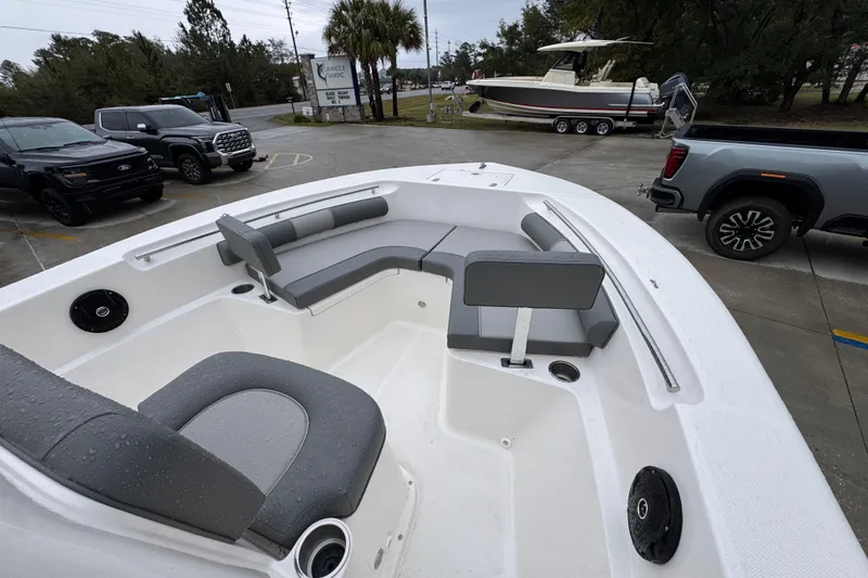Slide: The Image of 2026 Sea Born LX21 Center Console boat with gray seating, parked outdoors. - 16