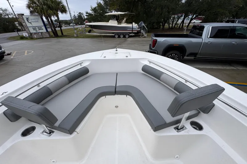 Slide: The Image of 2026 Sea Born LX21 Center Console boat with gray seating in a marina setting. - 17