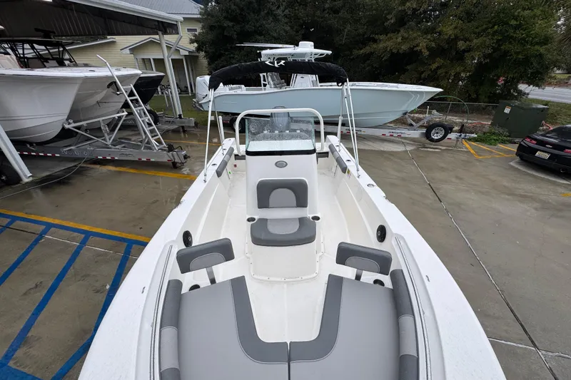 Slide: The Image of 2026 Sea Born LX21 Center Console boat in a parking lot, showcasing interior seating. - 20