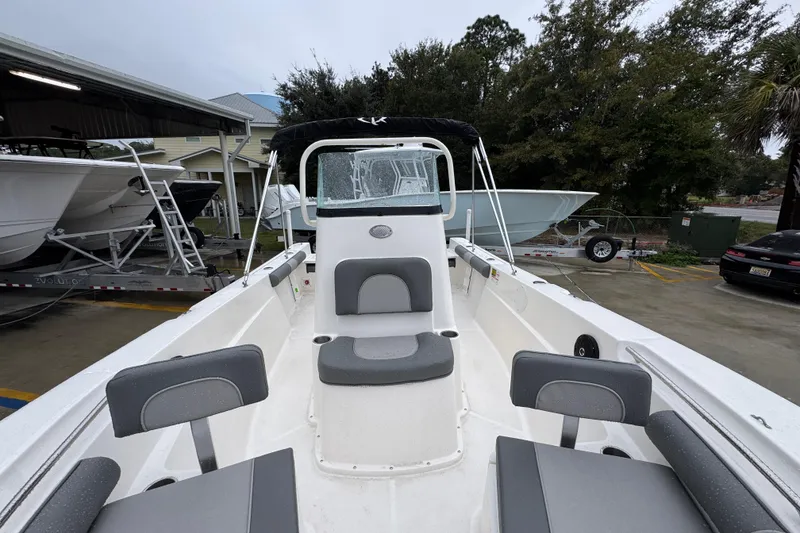 Slide: The Image of 2026 Sea Born LX21 Center Console boat with gray seating, parked outdoors. - 21