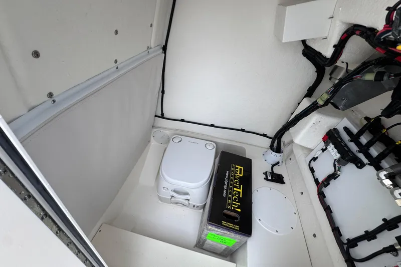 Slide: The Image of Interior of 2026 Sea Born LX21 Center Console boat with storage and wiring. - 25