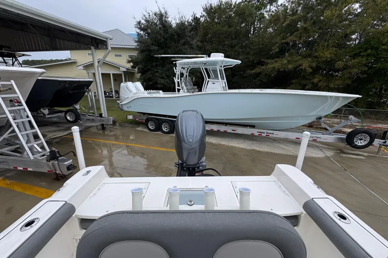 Slide: The Image of 2026 Sea Born LX21 Center Console boat on trailer, parked outdoors near buildings. - 27