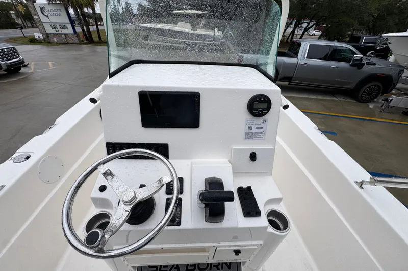 Slide: The Image of 2026 Sea Born LX21 Center Console boat interior with steering wheel and controls. - 29