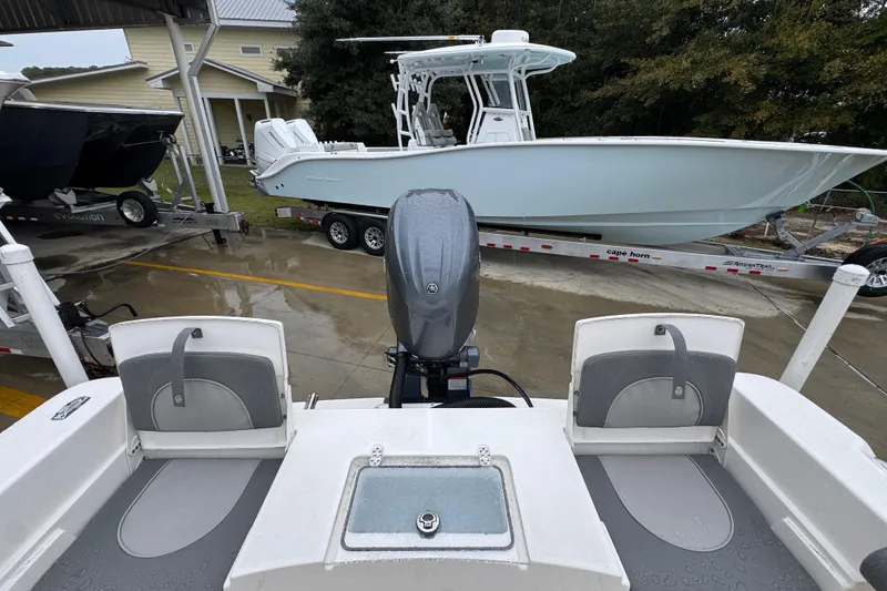Slide: The Image of 2026 Sea Born LX21 Center Console boat on trailer, viewed from rear deck. - 32
