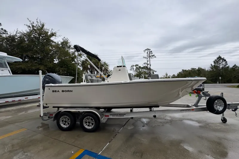 Slide: The Image of 2026 Sea Born LX21 Center Console boat on trailer, parked outdoors. - 8