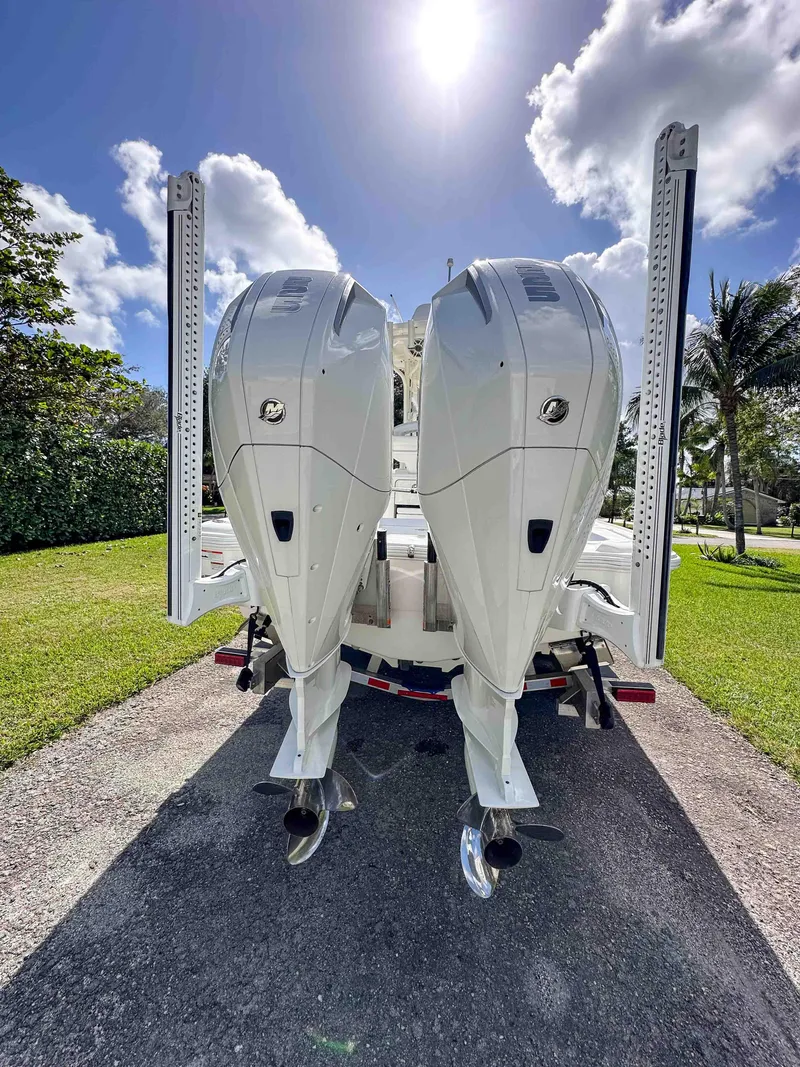 Slide: The Image of 2022 SeaVee 270Z boat with dual outboard engines, parked on a sunny day. - 10