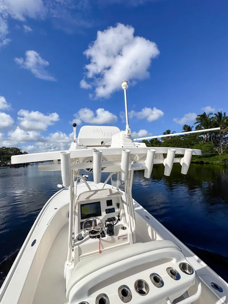 Slide: The Image of 2022 SeaVee 270Z boat on calm water under a clear blue sky. - 16