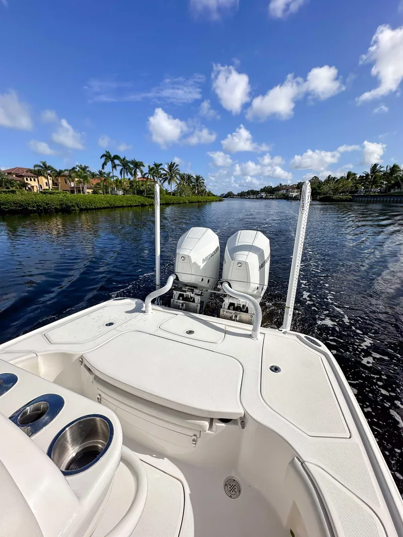 Slide: The Image of 2022 SeaVee 270Z boat cruising on a scenic waterway under a clear blue sky. - 30