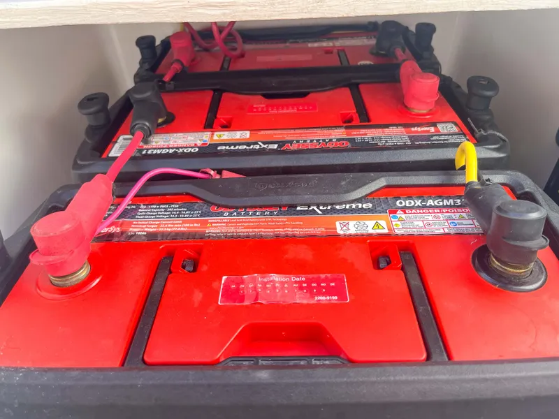 Slide: The Image of Batteries installed in a 2022 SeaVee 270Z boat, featuring red casings and connected terminals. - 36