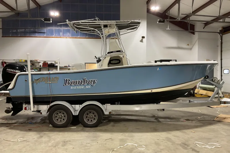 Slide: The Image of 2022 Mako 214 Center Console boat on trailer in indoor storage. - 5