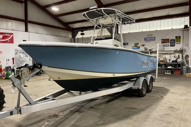 Slide: The Image of 2022 Mako 214 Center Console boat on trailer in a garage setting. - 7