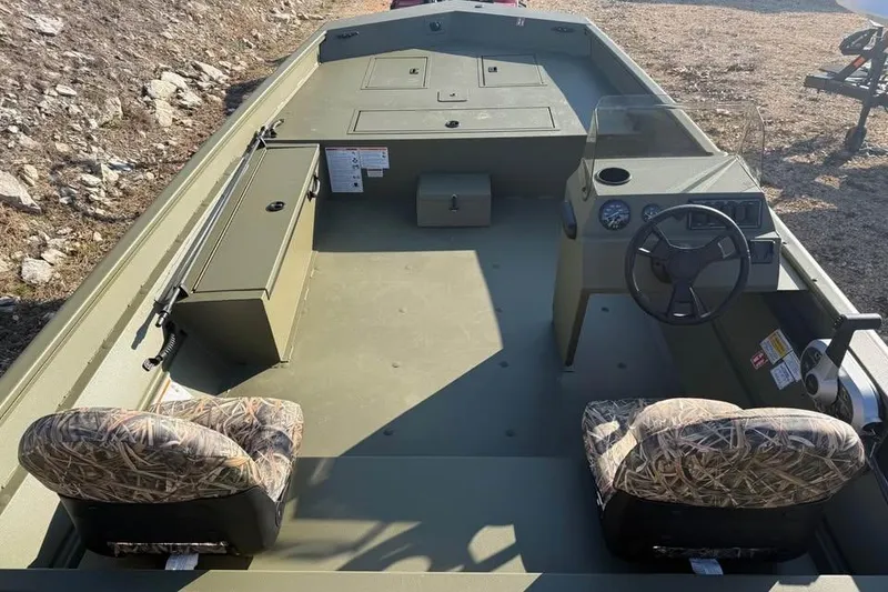 Slide: The Image of 2026 Lowe Roughneck 2070 boat interior with camo seats and steering console. - 10