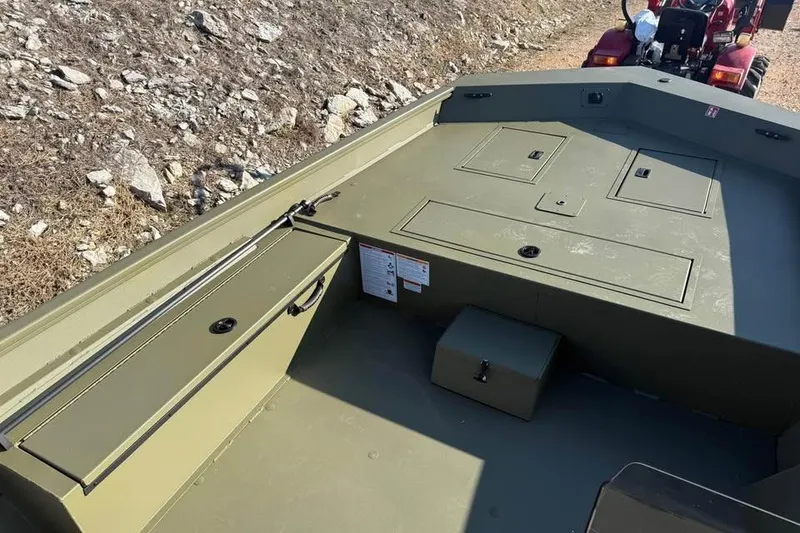 Slide: The Image of 2026 Lowe Roughneck 2070 boat interior with storage compartments and rugged design. - 11