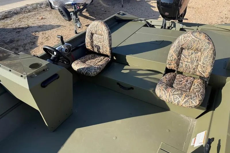 Slide: The Image of 2026 Lowe Roughneck 2070 boat interior with camo seats and steering console. - 14