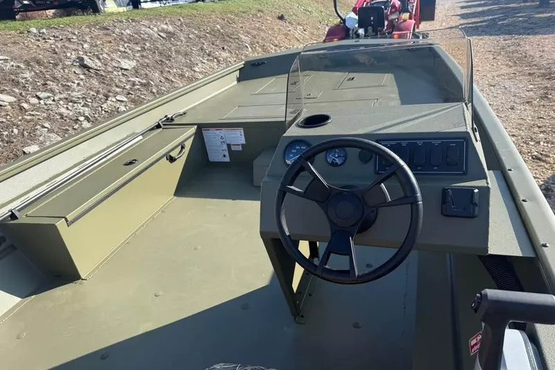 Slide: The Image of 2026 Lowe Roughneck 2070 boat interior with steering wheel and control panel. - 9