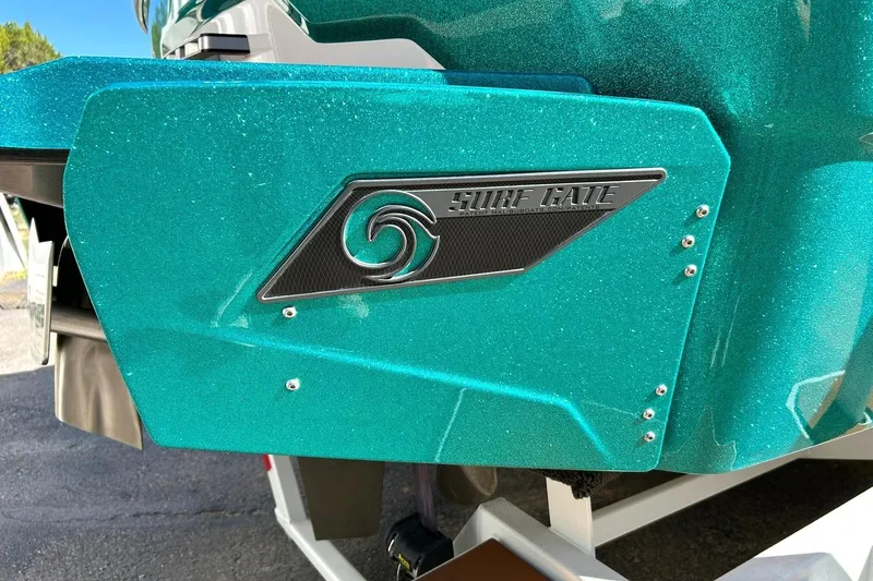 Slide: The Image of 2021 Axis A24 boat with teal Surf Gate feature for enhanced wakeboarding. - 21