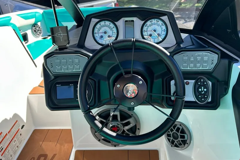Slide: The Image of 2021 Axis A24 boat dashboard with steering wheel and control panels. - 42