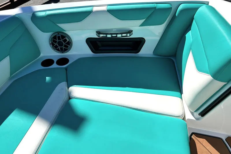 Slide: The Image of Interior of 2021 Axis A24 boat with teal and white seating. - 48