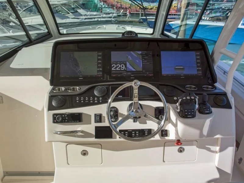 Slide: The Image of 2026 Grady-White Canyon 456 helm with advanced navigation instruments. - 17