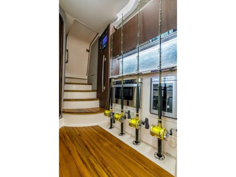 Slide: The Image of Interior of 2026 Grady-White Canyon 456 with fishing rods and wooden flooring. - 24