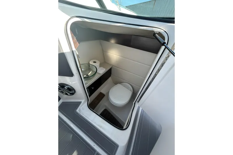 Slide: The Image of 2017 Regal 2900 Bowrider boat interior with compact bathroom and modern amenities. - 10