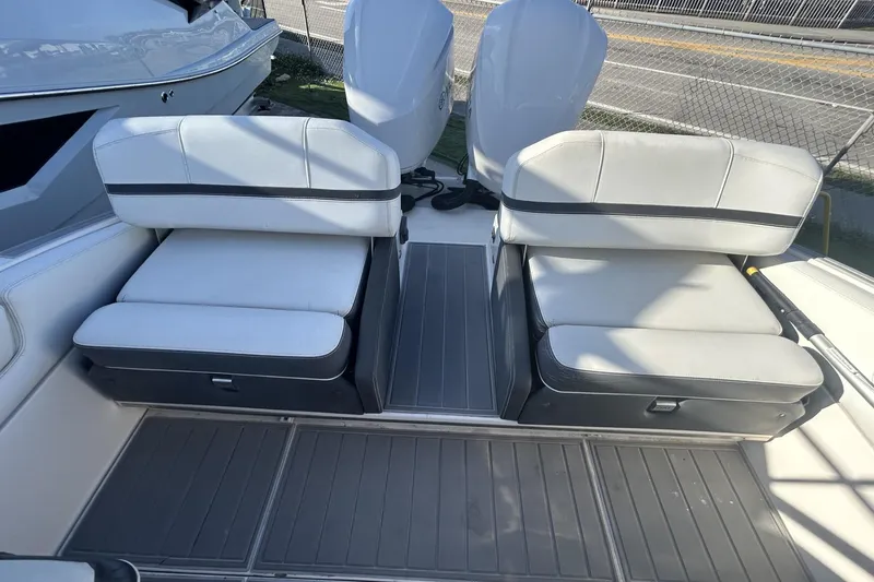 Slide: The Image of 2017 Regal 2900 Bowrider boat interior with dual white cushioned seats. - 14