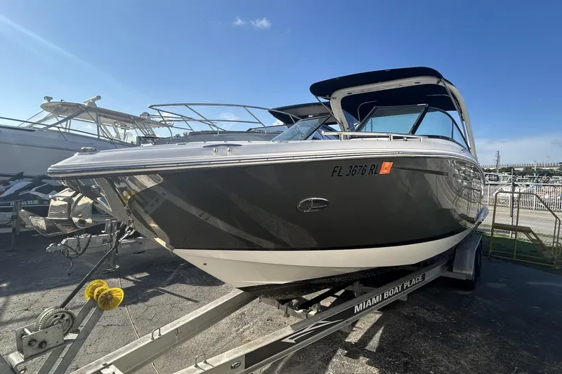 Slide: The Image of 2017 Regal 2900 Bowrider boat on trailer under clear blue sky. - 3